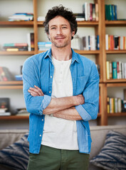 Mature man, portrait and arms crossed in home with smile, confidence and pride by bookshelf in...