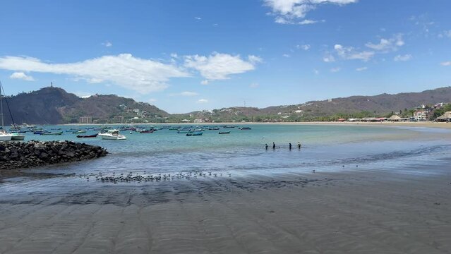 Beautiful view of the San Juan del Sur Beach in Nicaragua, the duck and boats on shore 