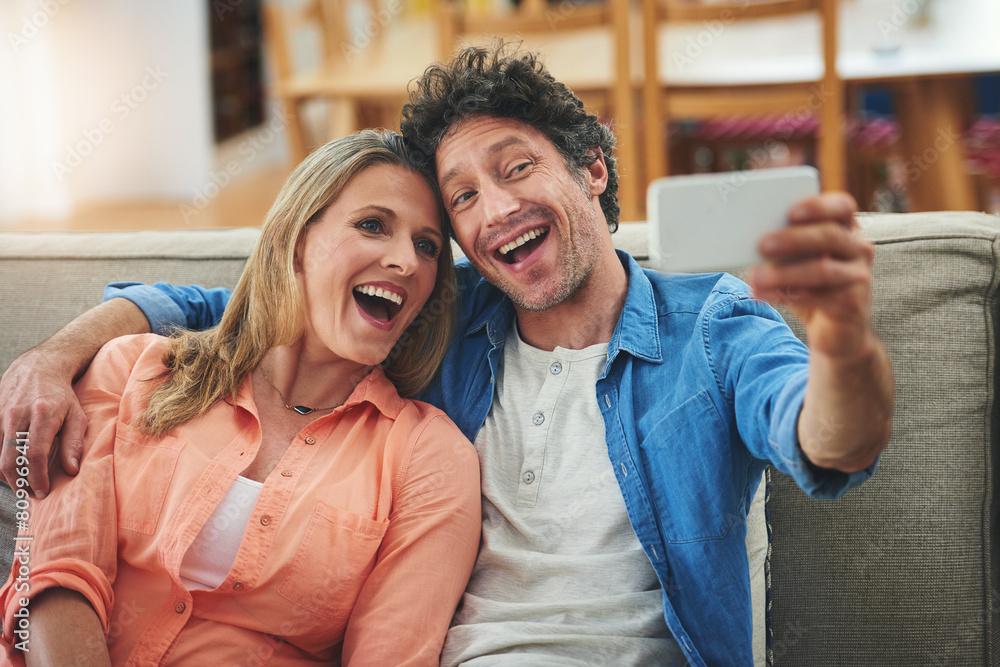 Poster couple, selfie and couch in home, smile and excited for memory with bonding for love with connection