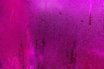 pink textured abstract wet glass background. empty space
