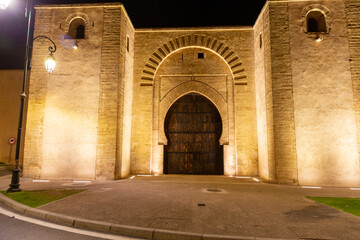 Entrance gate to the old medina and the Kasbah fort fort. Night view of a street of the historical...