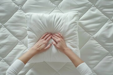 A person hiding their face behind a pillow. Suitable for concepts of hiding, privacy, or sleep