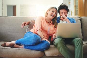 Mature, couple and laughing with laptop on couch for comedy movie, funny series or streaming...