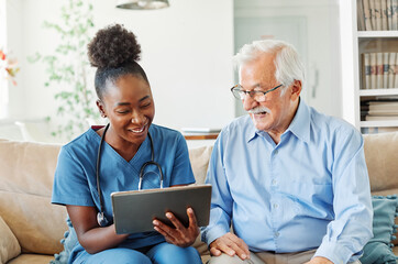 nurse doctor senior care tablet computer technology showing caregiver help assistence retirement...