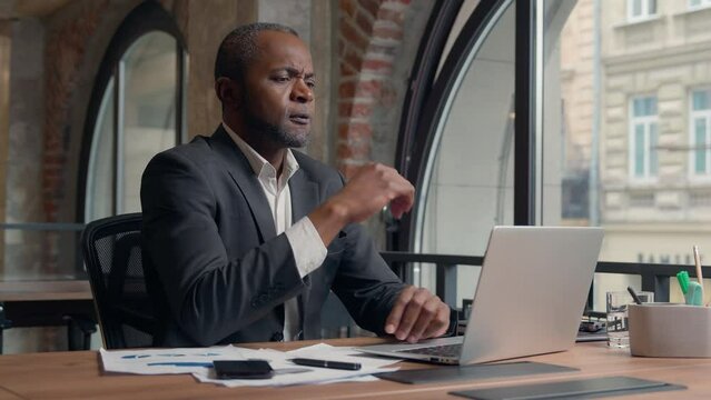 African American middle-aged entrepreneur typing laptop computer thinking problem trouble gloomy thoughtful hesitate unsure decide solution think idea business man office businessman male guy puzzled