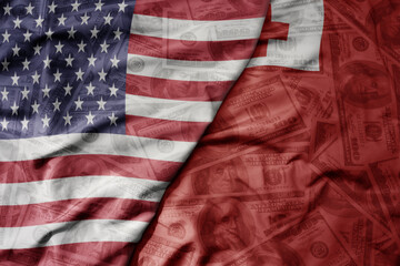 big waving colorful flag of united states of america and national flag of Tonga on the dollar money background. finance concept.