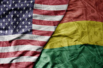 big waving colorful flag of united states of america and national flag of bolivia on the dollar money background. finance concept.
