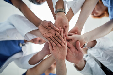 Doctor, hands together and below with medical team for meeting, unity or motivation at hospital....