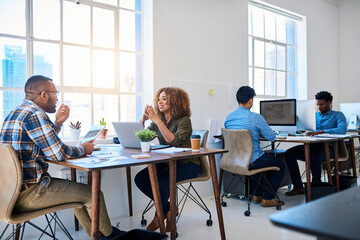 Business people, desk and talking for creative project as designer team for startup, campaign or brainstorming. Man, woman and laptop with office meeting for target audience, research or planning