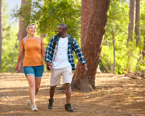 Loving Couple Holding Hands On Outdoor Hike In Countryside Together