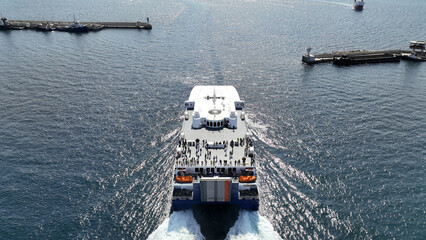Aerial drone photo of high speed Seajet passenger vessel leaving port of Piraeus to Aegean Cycladic...