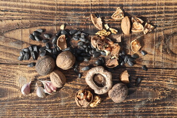 Composition with walnuts and seeds on wooden background, top view