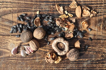 Composition with walnuts and seeds on wooden background, top view