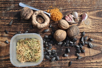 Composition with walnuts and seeds on wooden background, top view