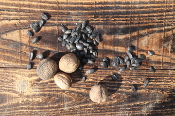 Composition with walnuts and seeds on wooden background, top view