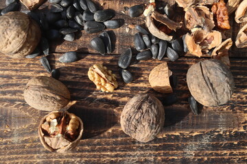 Composition with walnuts and seeds on wooden background, top view