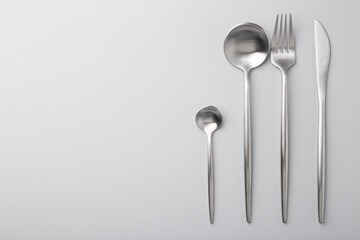 Stylish cutlery set on grey table, flat lay. Space for text