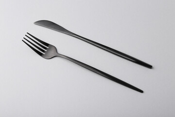 Stylish cutlery on grey table, above view