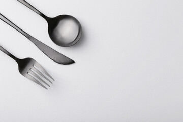 Stylish cutlery set on grey table, flat lay. Space for text