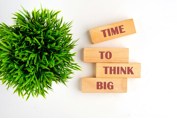 Business and Time to think big concept. Time to think big symbol on wooden blocks on a white background, top view
