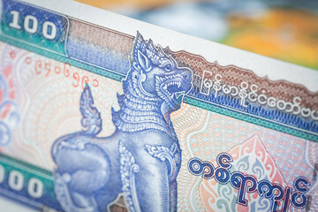Myanmar money, 100 Burmese kyat banknote against the background of the world, financial market...