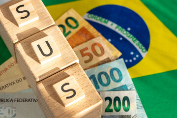 Brazilian healthcare, word SUS meaning unified healthcare system written on wooden cubes. Symbols...