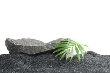 Presentation of product. Stone podium and palm leaves on black sand against white background