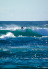 surfing the wave Porto Ferro, Sardinia, Italy