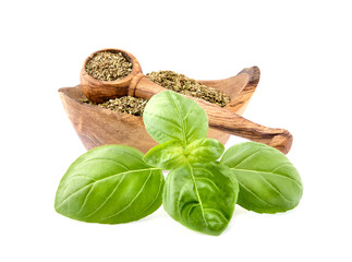 Basil leaves in closeup on white background. Basil Spice in wooden spoon .