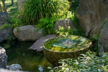 Small fountain in Japanese garden of Monaco inside  stone