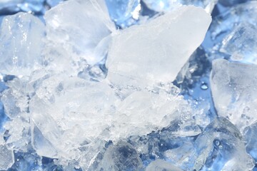 Pieces of crushed ice on light blue background, above view