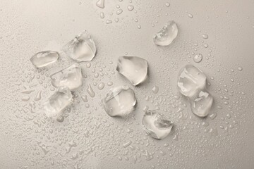 Pieces of crushed ice on grey background, top view