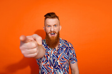 Photo of furious angry guy dressed print shirt pointing fingers you emtpy space isolated orange...