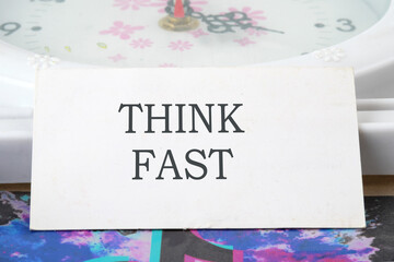 THINK FAST text on a white card