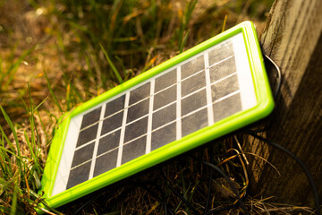 compact solar panel in the grass in the sun