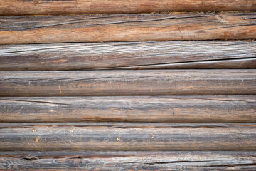 Wooden background with cracked logs Old wooden wall of a rustic house with texture