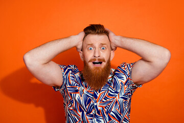 Photo of funky impressed guy dressed print shirt arms head open mouth isolated orange color background