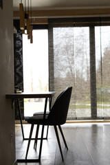the interior of the kitchen-living room, chairs and a table against the background of panoramic...