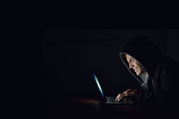 Dark, office and man at laptop for hacking, online programming and cybersecurity at night....