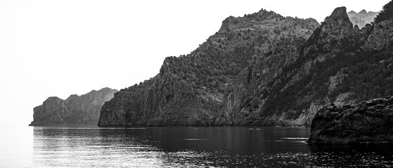 Monochrome panorama of Mallorca cliff coastline, calm Mediterranean Sea meets untouched shores,...