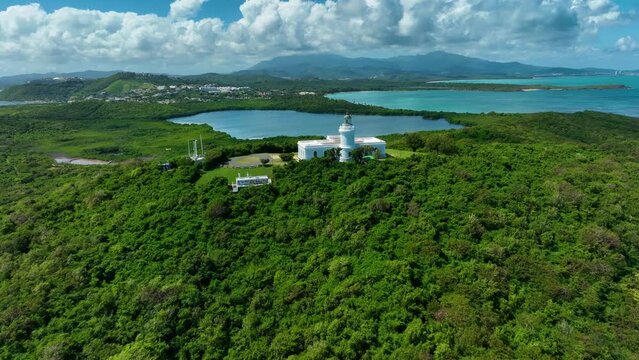 Aerial drone footage of the lighthouse at Fajardo, Puerto Rico, with the bioluminescent bay, and El Yunque mountains, in the background.