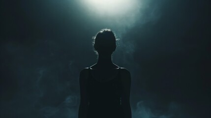 Silhouette of a woman in misty moonlight