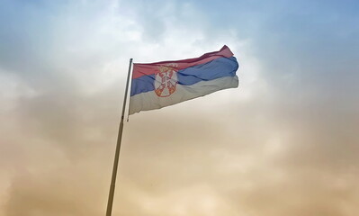 Serbian flag flies in the sky