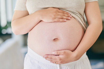 Hands, woman and pregnant stomach in home for love or excitement for parenthood, motherhood and...