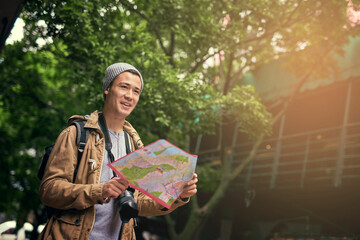 Asian man, map and city travel for directions or urban sightseeing in China, searching or reading. Male person, paper and guide for outdoor tourism for weekend journey or park, location or geography