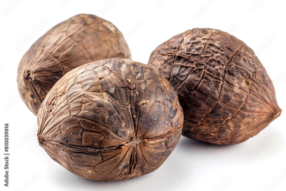 Poster three whole nut shells on a white surface. suitable for food or natural ingredient concepts