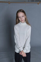 Youthful grace in a soft turtleneck, her stance relaxed yet confident. Perfect for portraying...