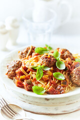 Spaghetti Pasta with Meatballs and fresh Basil o bright background. Close up.	