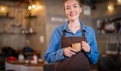 Professional Barista's holding coffee cup in coffee shop.