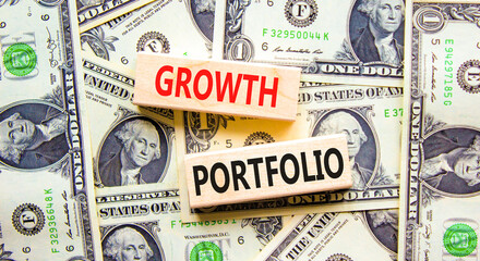 Growth portfolio symbol. Concept words Growth portfolio on beautiful wooden block. Beautiful dollar bills background. Dollar bills. Business Growth portfolio concept. Copy space.